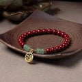 Handcrafted wave-shaped bracelet made from cinnabar and copper beads in national style