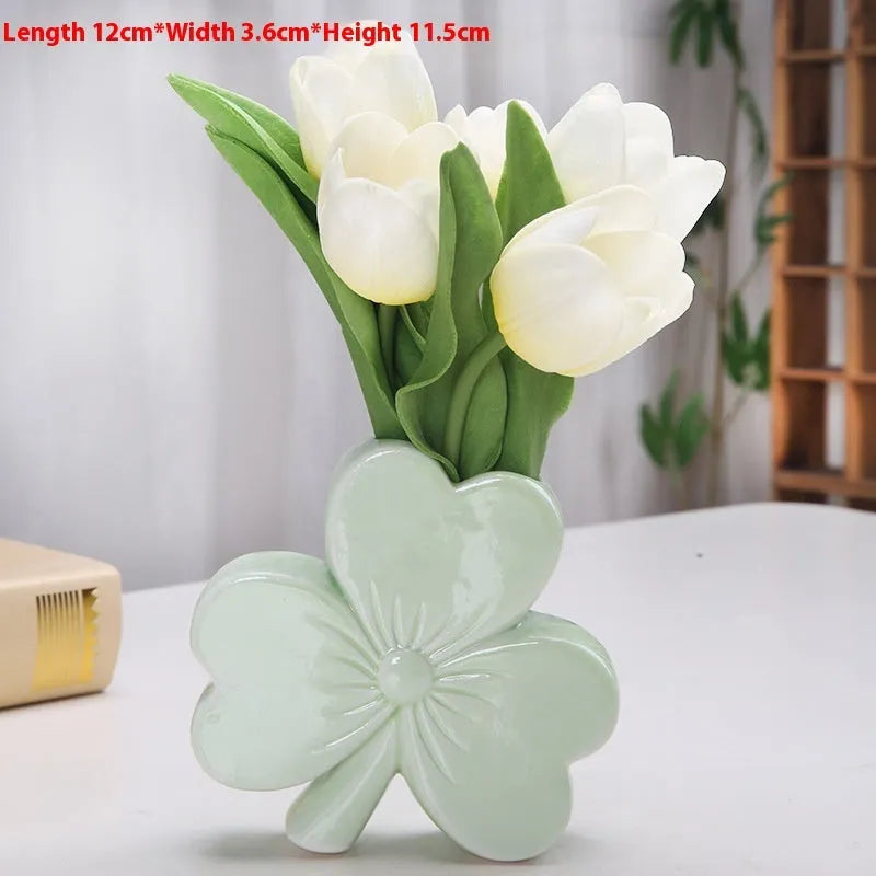 Clover-shaped white porcelain vase in European style on a desktop.