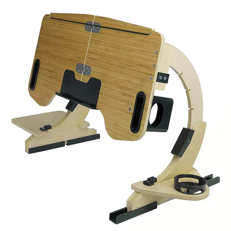 Wooden folding laptop table with adjustable angle on a bed, in black finish.