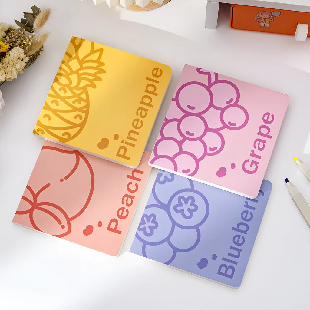 Square notebook with embossed fruit design cover, showing 14.5 cm dimensions and open pages.