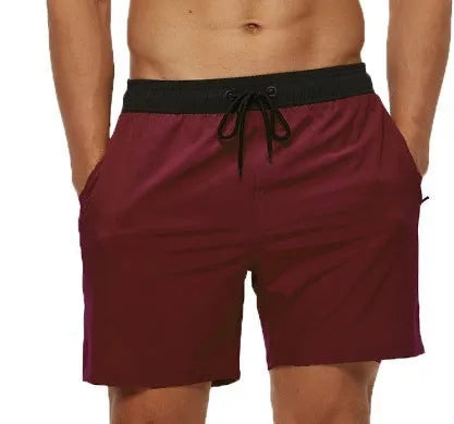 Men's blue drawstring shorts with stitched waistband and zippered pockets, shown for running and fitness use.
