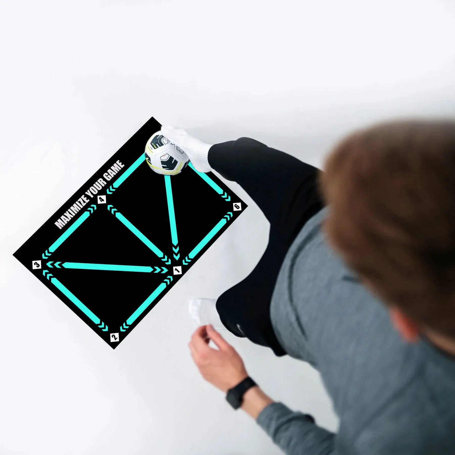 Black rectangular football training mat measuring 60 by 90 centimetres on a flat surface.