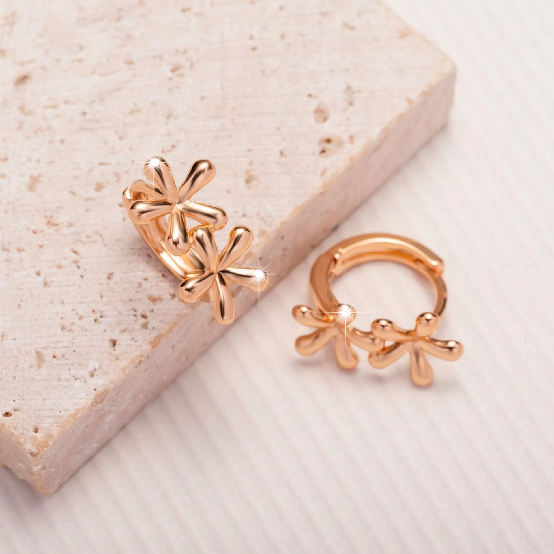 Rose gold coloured circular waterdrop flower earrings with an electroplated finish.