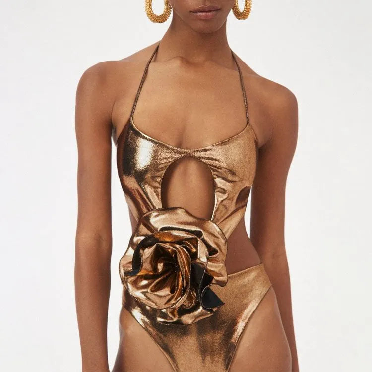 Gold handmade one-piece swimsuit with halter neck and hollow-out design on a mannequin.