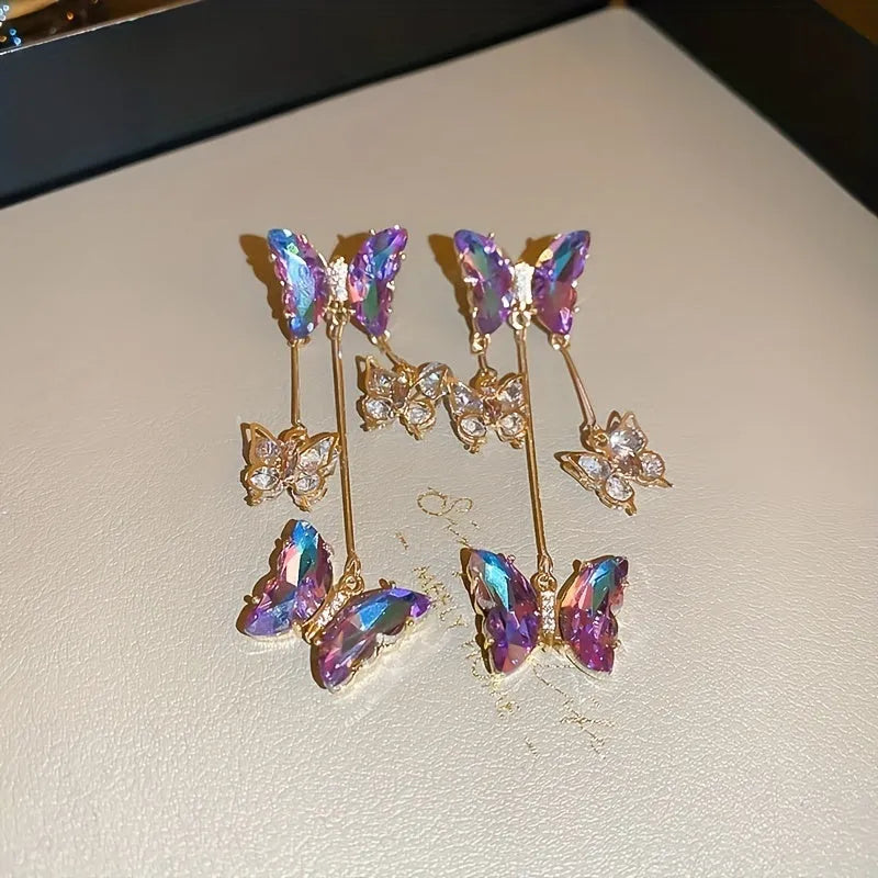 Blue purple butterfly tassel earrings with silver crystal flowers on alloy settings.