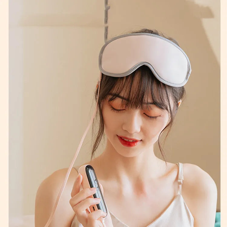 Green portable eye massage goggles showing USB connection and suede exterior