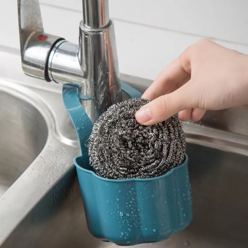 Dark blue plastic sink drain basket with Nordic design on a kitchen counter.