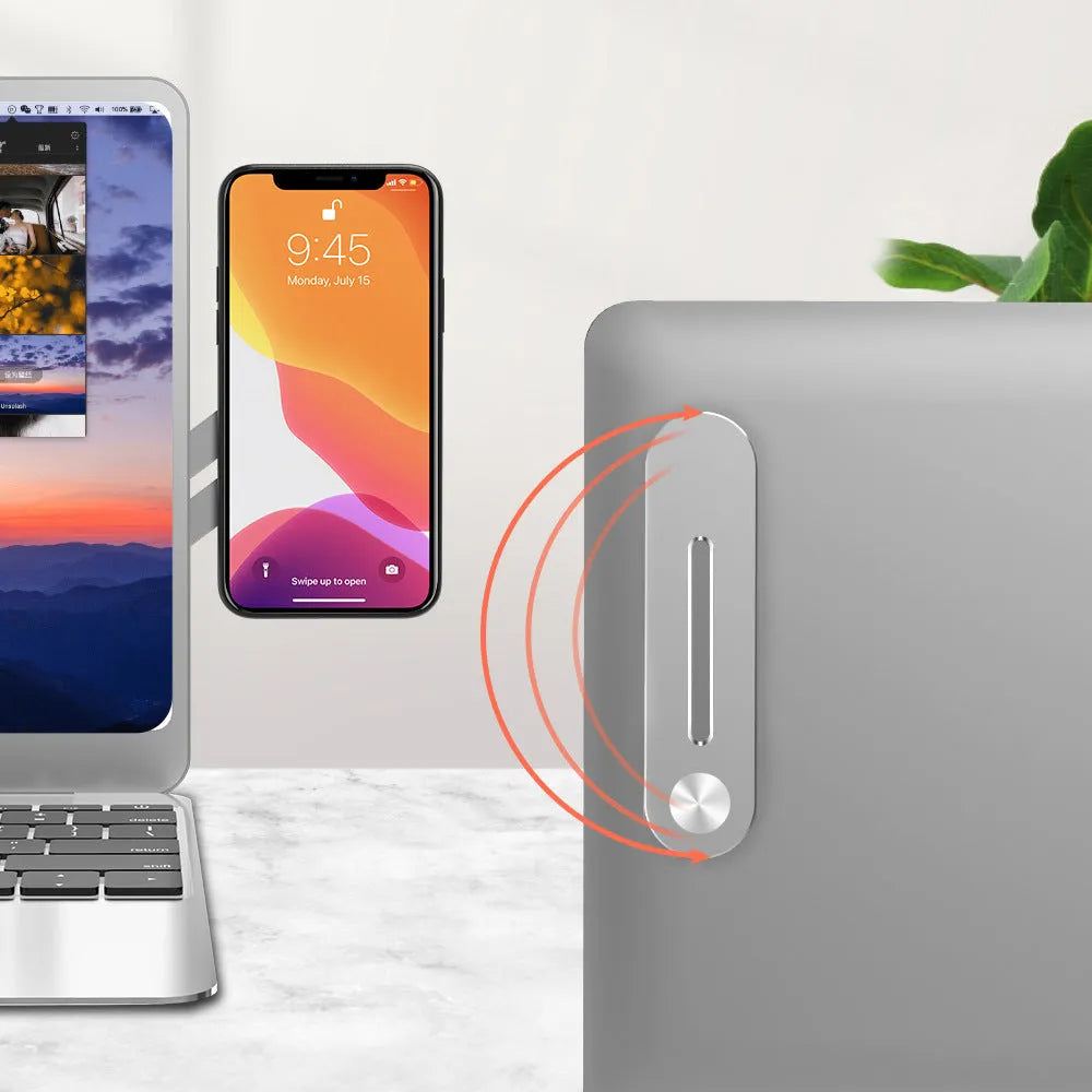 Aluminium laptop side mount bracket holding a mobile phone next to a computer screen.
