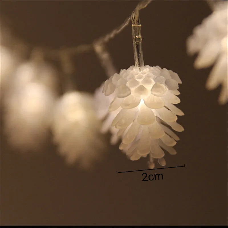 Battery-powered LED light string with plastic pine cone shells, shown in warm white and colour options.