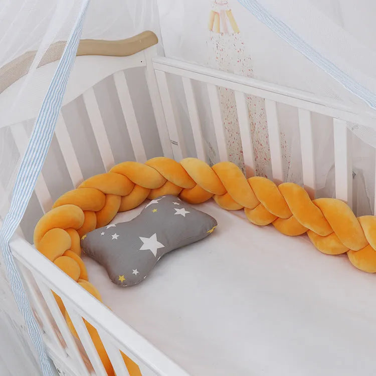 Braided knot design baby crib bumper in spandex velvet, shown in a light grey colour.
