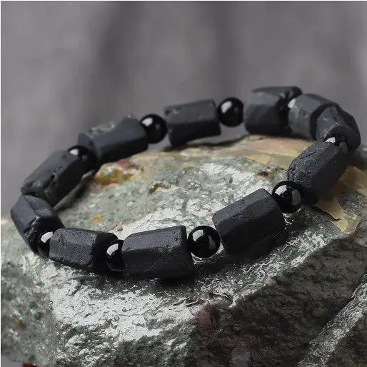 Unisex adjustable bracelet with rough, dark black tourmaline beads on a black cord.