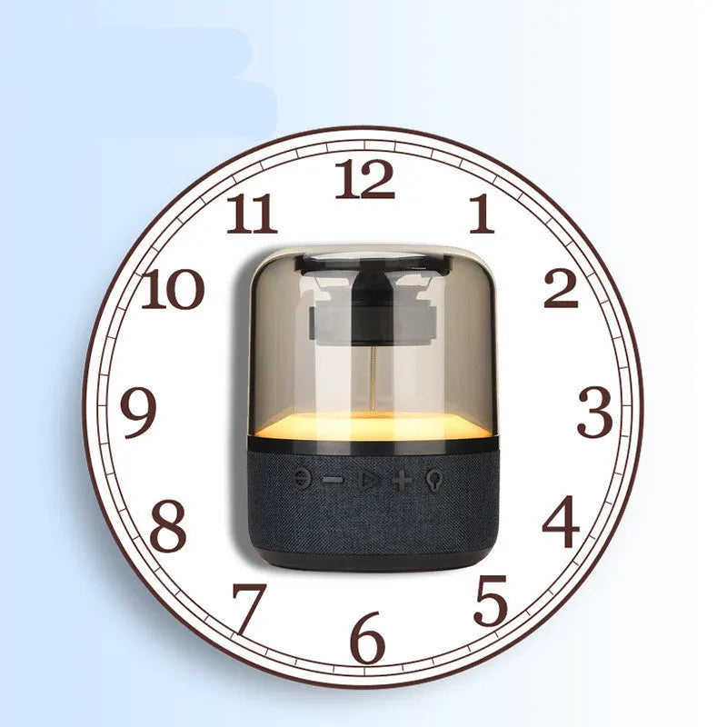 Black wireless Bluetooth speaker with multi-colour LED halo lights glowing around its base.