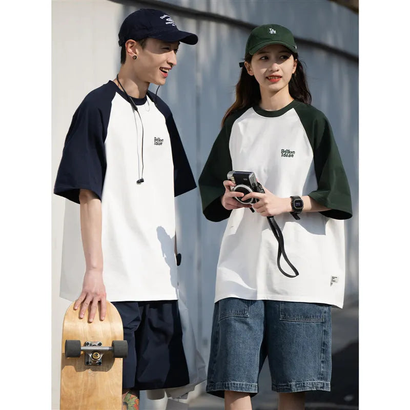 Men's blue loose-fit casual t-shirt with raglan sleeves on a hanger.