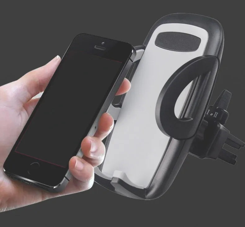Black plastic mobile phone holder clipped to a car air conditioning vent.