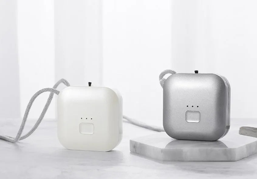 Mini USB air purifier necklace in pink, showing compact dimensions and wearable design.