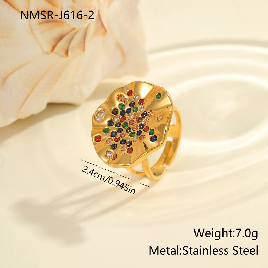 Pleated geometry open mouth ring with inlaid colourful crystals on electroplated stainless steel band.