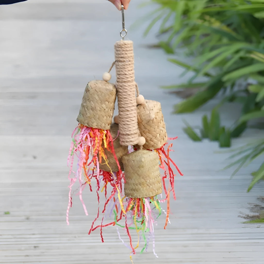 Parrot toy with wood and sisal construction containing colourful shredded paper, 15cm by 35cm