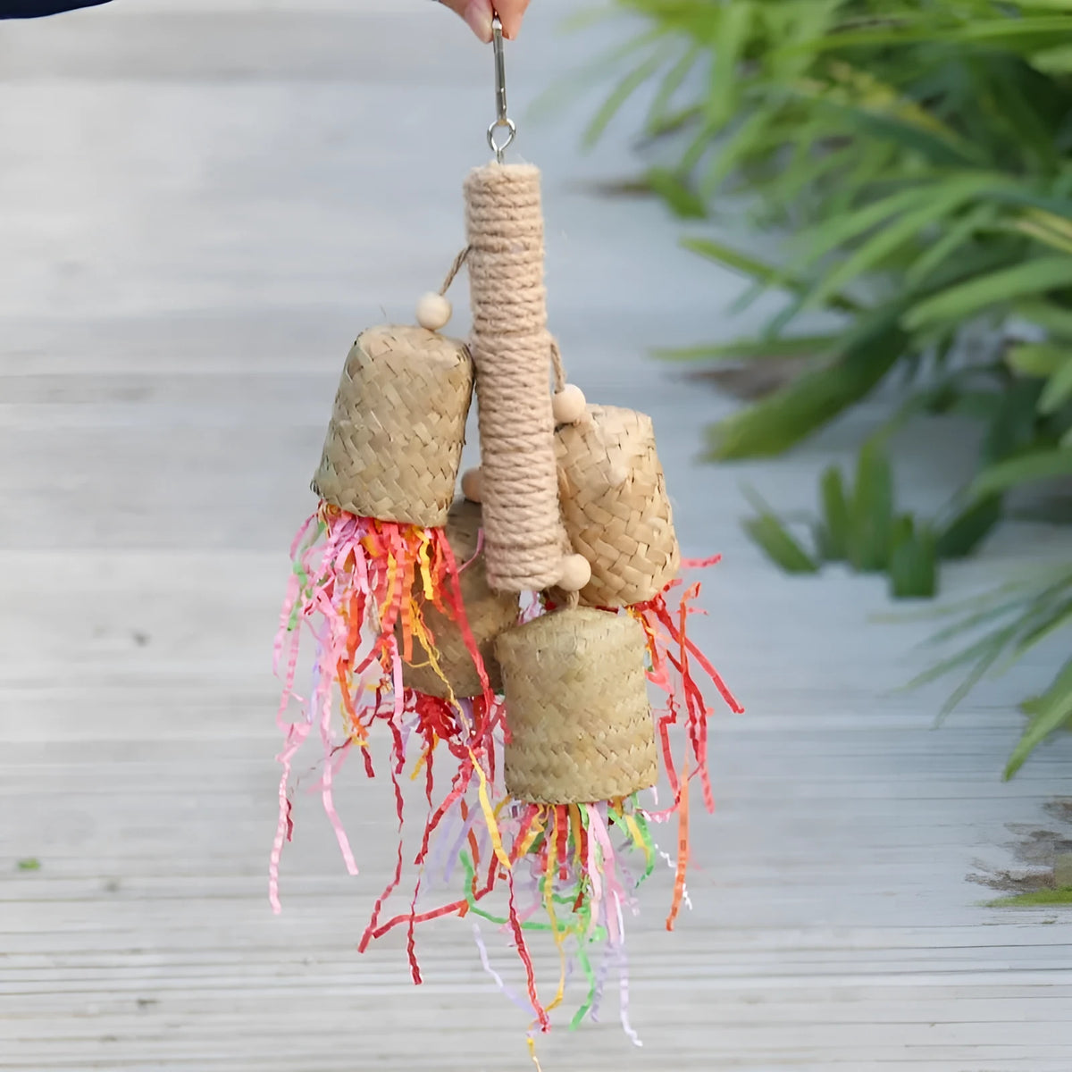 Parrot toy with wood and sisal construction containing colourful shredded paper, 15cm by 35cm