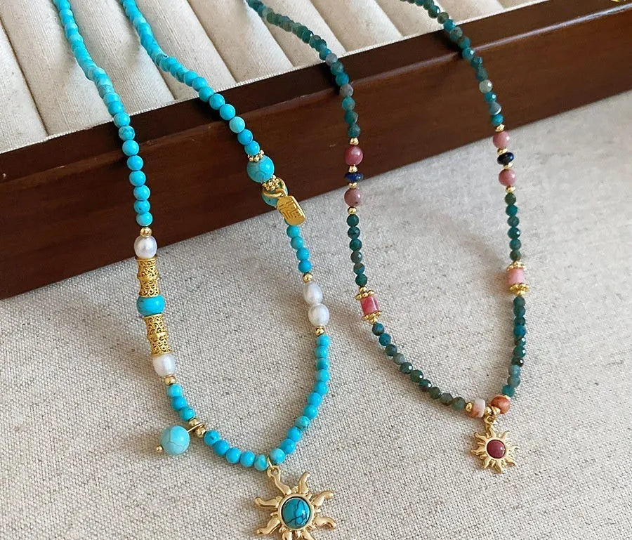 Freshwater pearl necklace with geometric sun stone pendant on adjustable clavicle chain