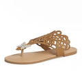 Women's black slip-on sandals with rhinestone detail and a flip-toe design on a flat rubber sole.