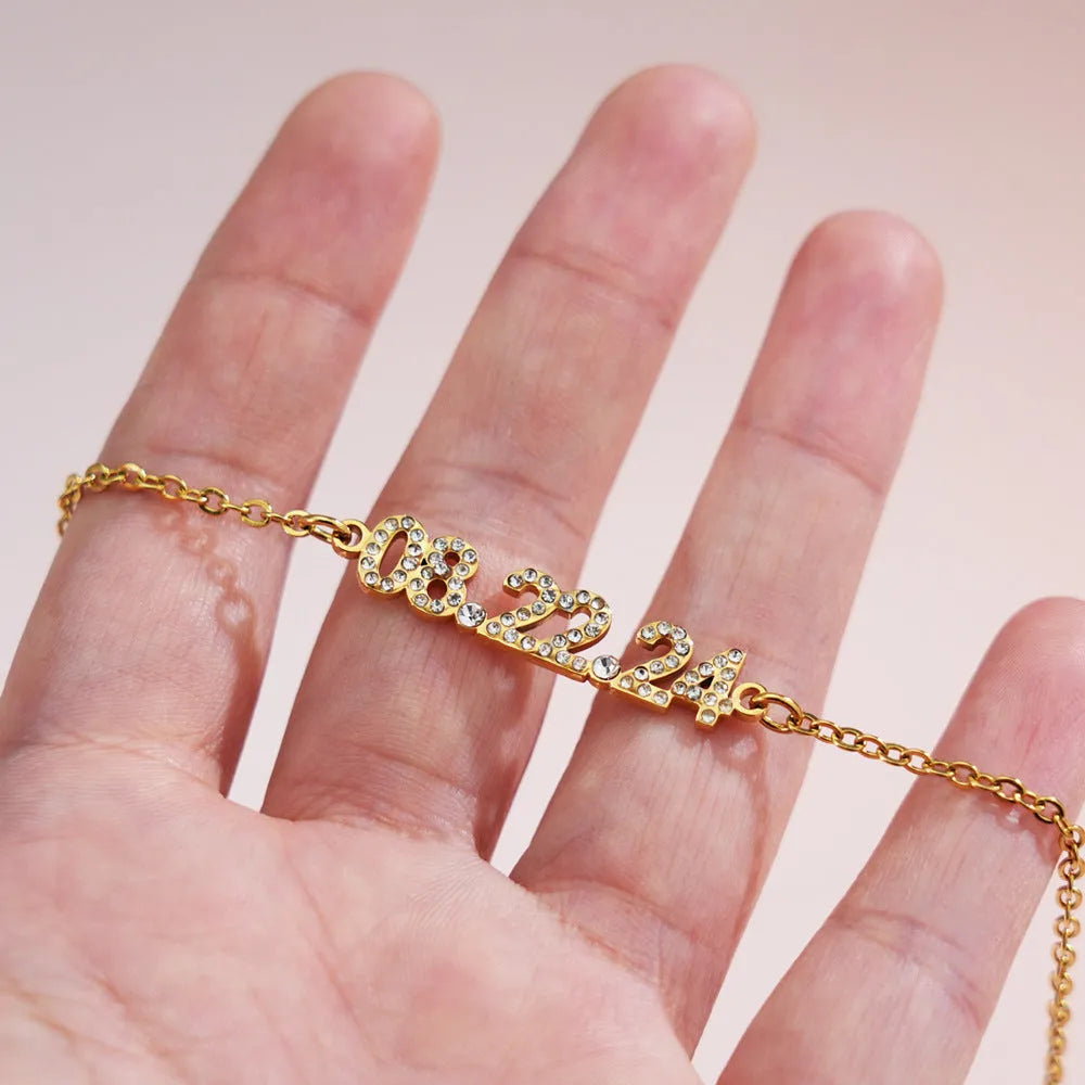 Stainless steel digital bracelet or necklace with diamond studs and clear number display.