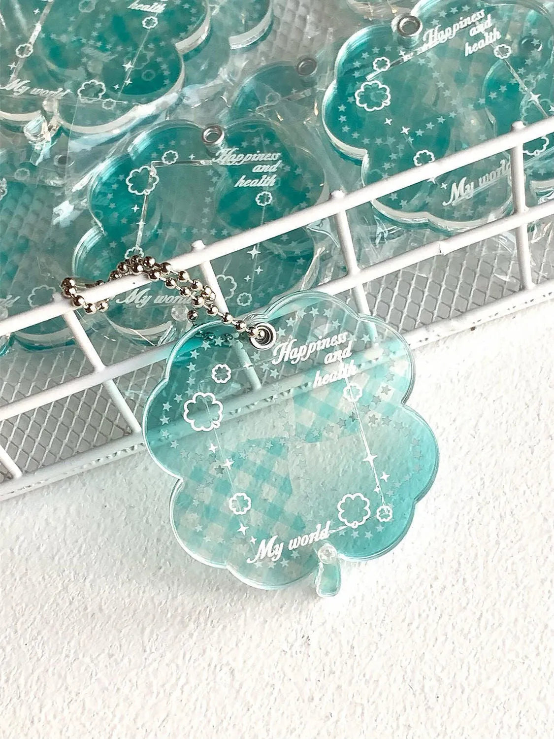 Acrylic four-leaf clover pendant keychain in elegant blue, grass green, and mint green colours.