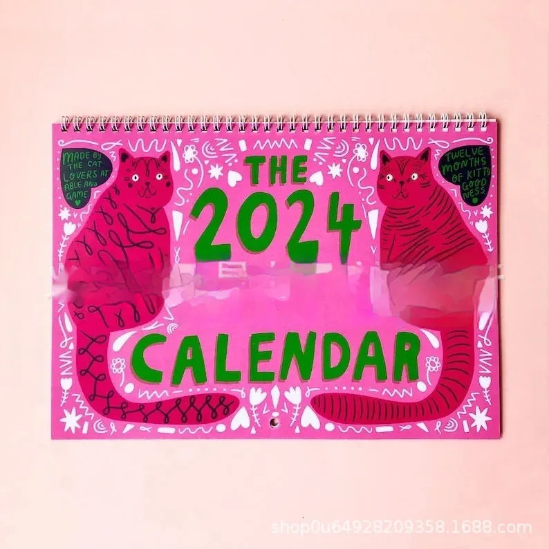 A cat-themed paper wall calendar for 2024 or 2025 displayed flat.
