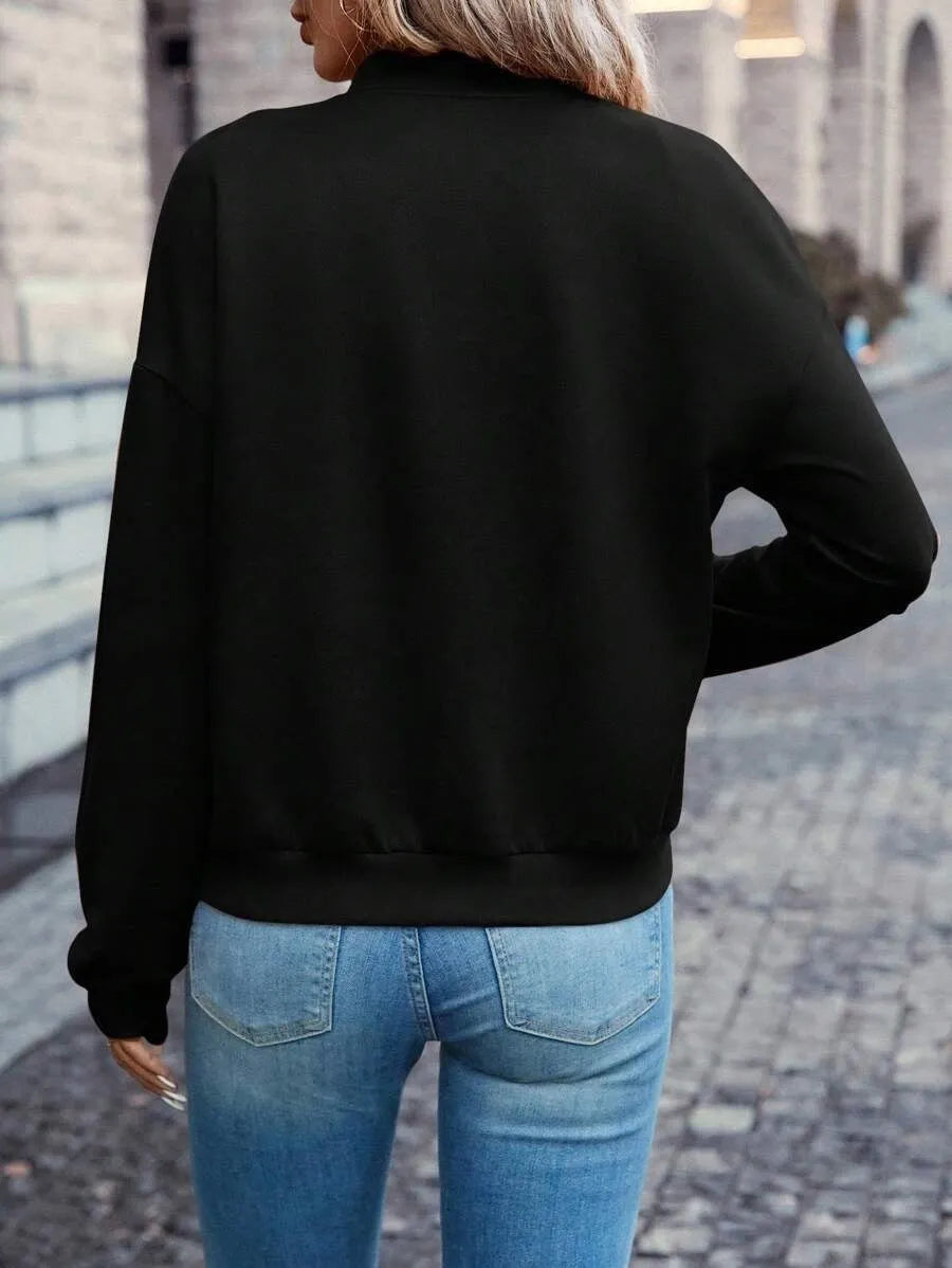 Black women's casual zip jacket with long sleeves on a hanger