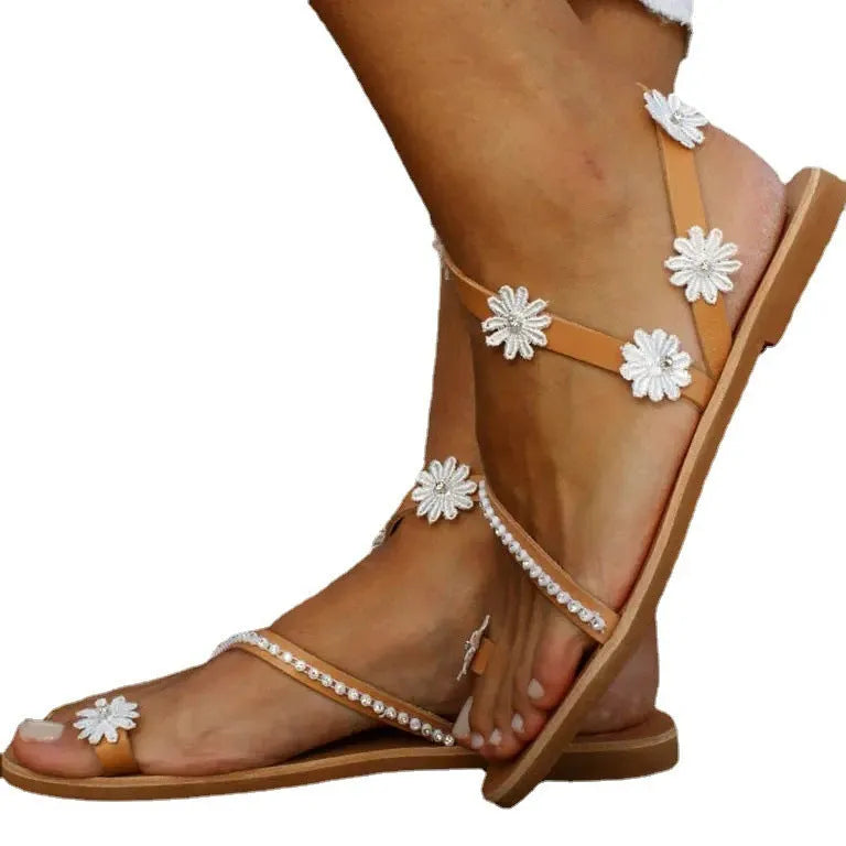 Brown women's casual sandals with flat rubber soles and floral decorations on the upper.