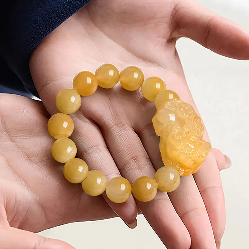 Hand-carved Jinsi Jade money bracelet showing golden thread colour, available in large or small sizes with different bead diameters.