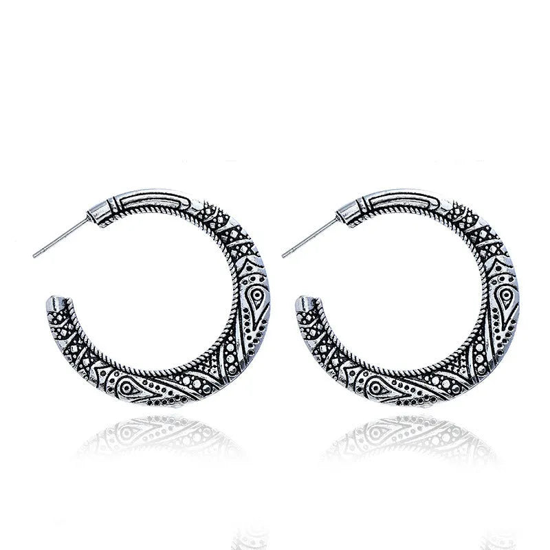 C-shaped alloy earrings with vintage engraving pattern in bronze colour showing curved design and butterfly clasp