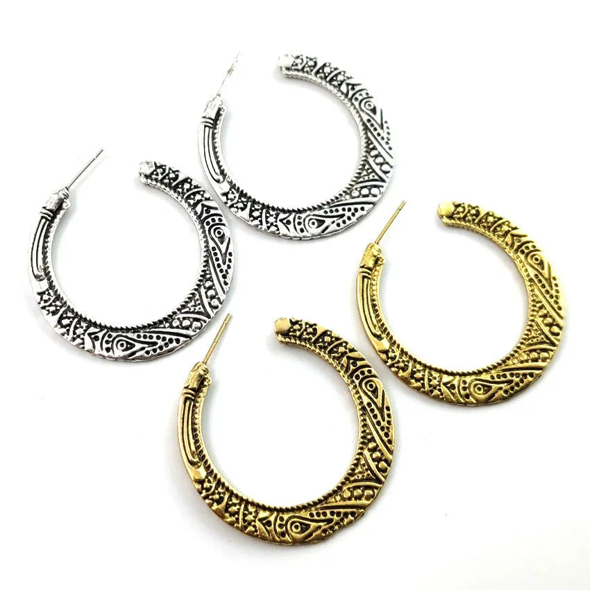 C-shaped alloy earrings with vintage engraving pattern in bronze colour showing curved design and butterfly clasp