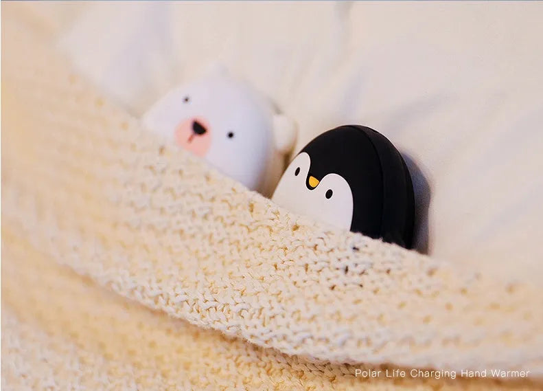 Cute cartoon penguin polar bear design USB rechargeable hand warmer and power bank unit.
