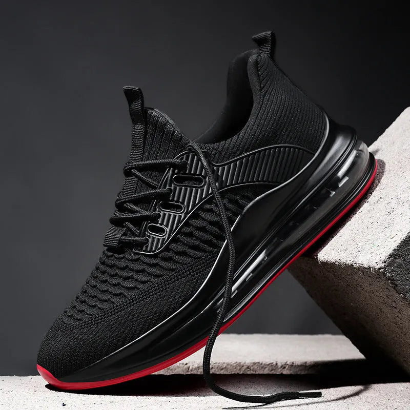 Men's low-top black breathable mesh running sneakers with white rubber sole on a solid background.