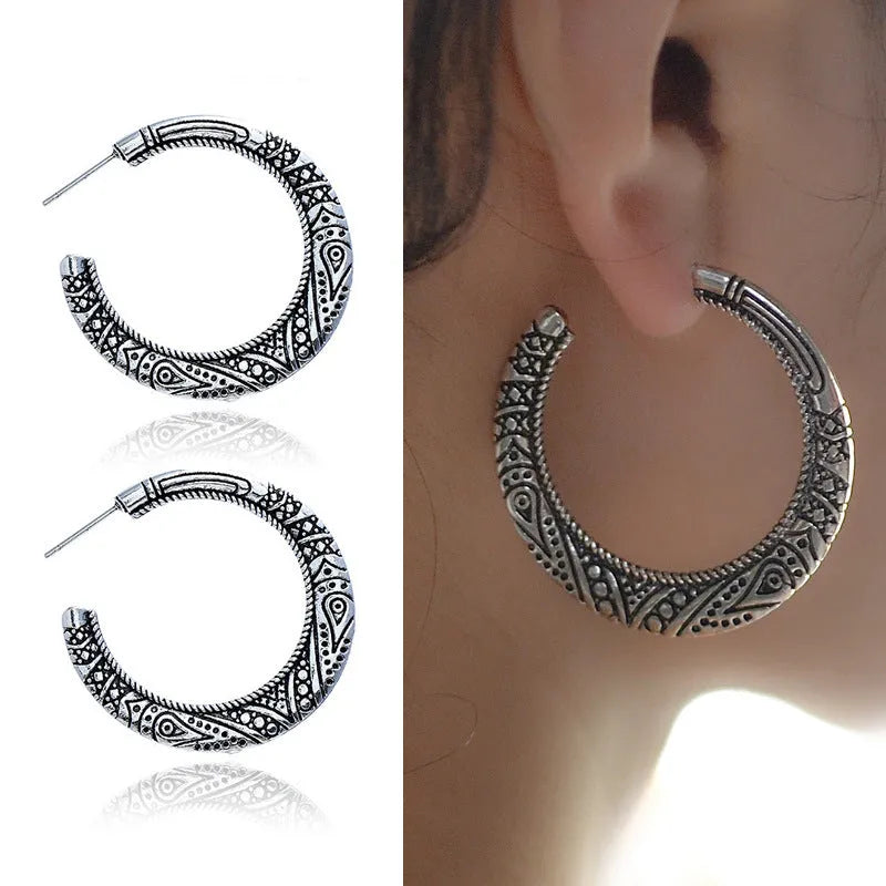C-shaped alloy earrings with vintage engraving pattern in bronze colour showing curved design and butterfly clasp