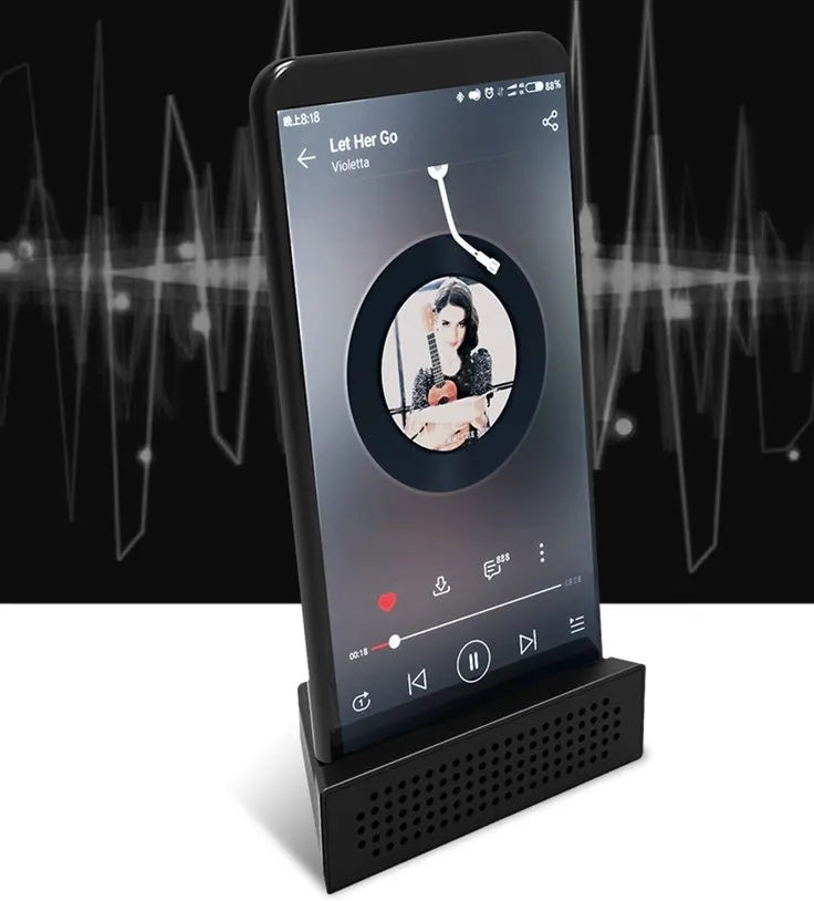 ABS mini mobile phone amplifier bracket in pink, holding a smartphone horizontally on a desktop.