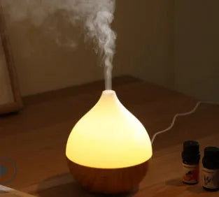 Wood grain finish vase-shaped USB aroma diffuser with 100ml water tank.