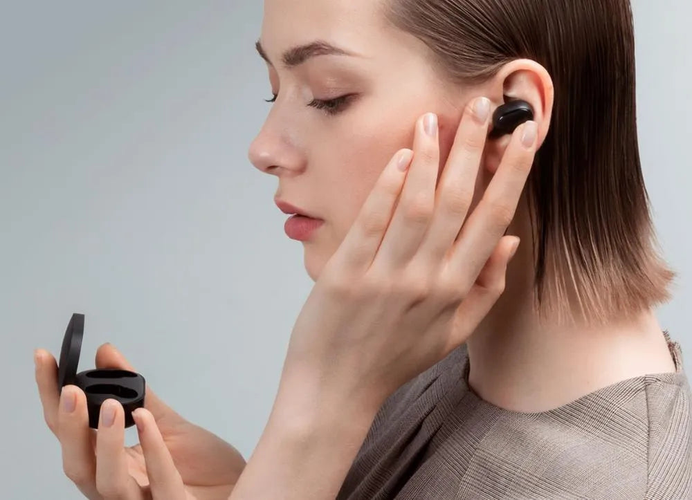 Black Redmi AirDots 2 true wireless earbuds and charging case on a white background.