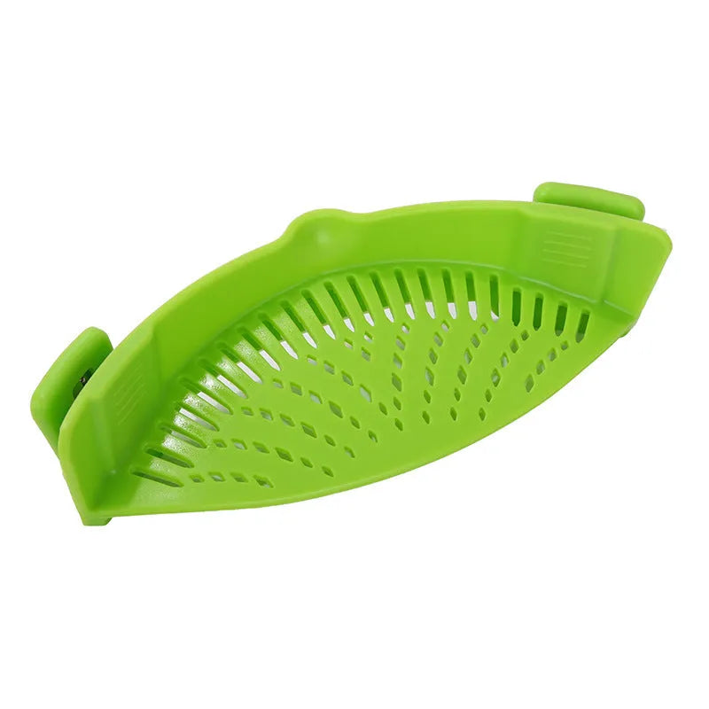 Silicone clip-on funnel strainer attached to kitchen pot for draining liquids