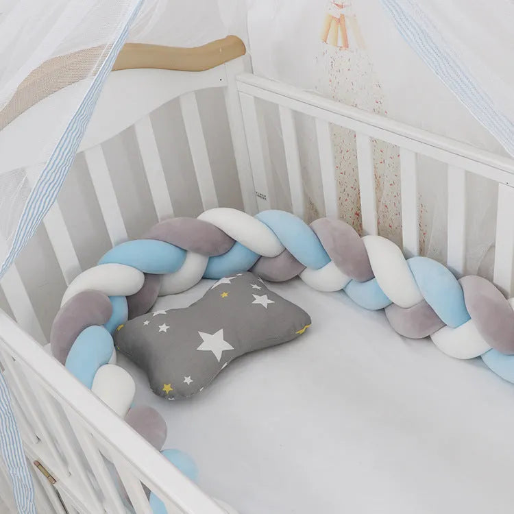 Braided knot design baby crib bumper in spandex velvet, shown in a light grey colour.