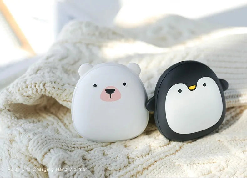 Cute cartoon penguin polar bear design USB rechargeable hand warmer and power bank unit.