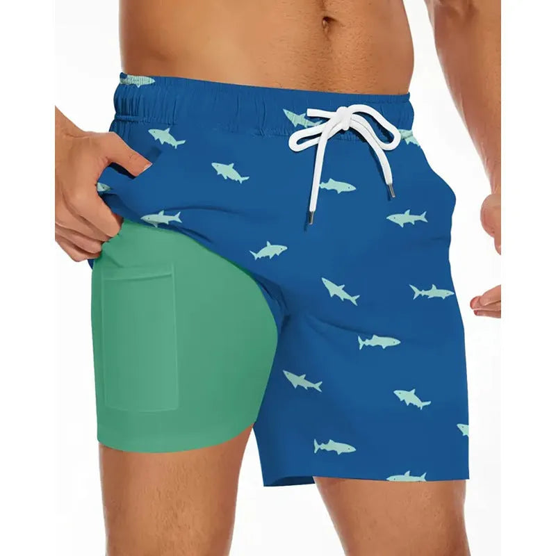 Man wearing loose grey polyester beach shorts, showing sporty casual style.