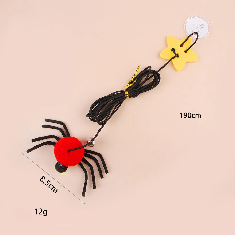 Red and yellow hanging door cat toy with elastic rope, feather, bell, and spider attachments