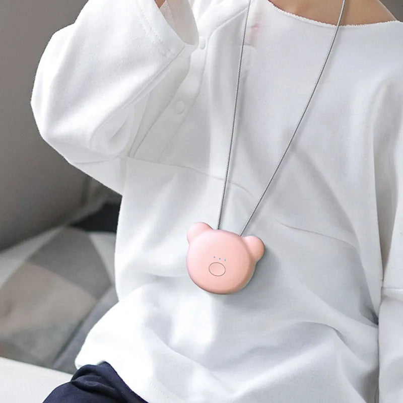 Mini USB air purifier necklace in pink, showing compact dimensions and wearable design.