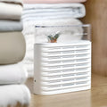 White recyclable dehumidifier box for cabinets with transparent lid showing colour-changing crystals and compact size.