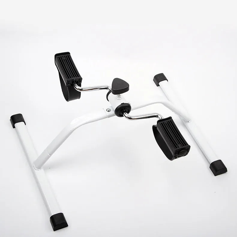 White mini exercise bike with mechanical resistance, non-slip pedals, rubber feet and 150kg maximum load