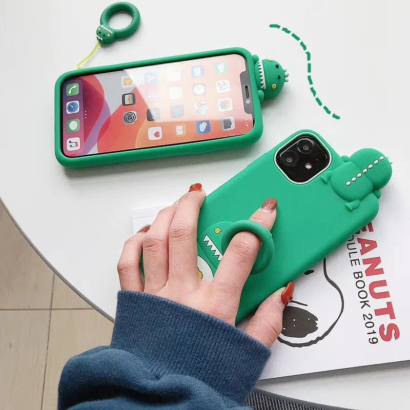 Green silicone iPhone case with cartoon animal design showing drop and waterproof protection features