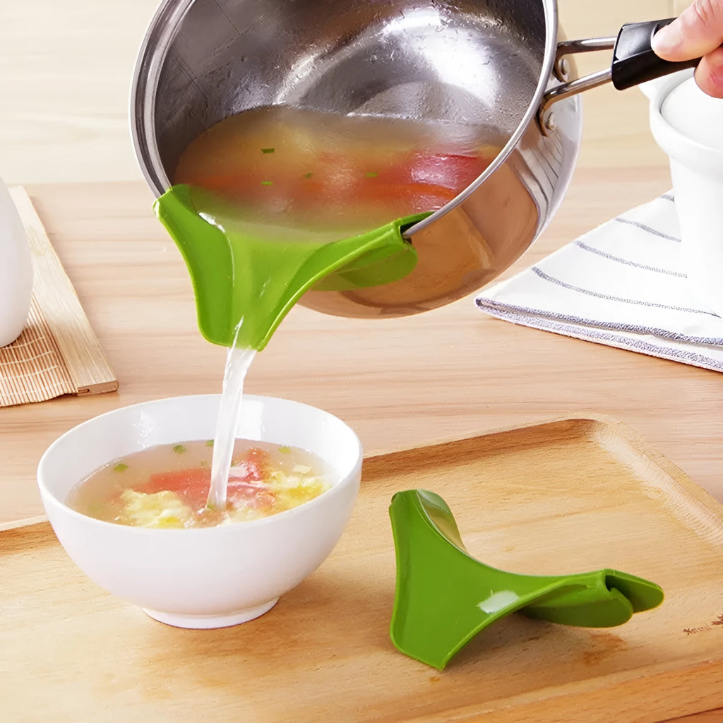 Green silicone soup funnel, 12 x 3 x 4.5 cm, clipped to edge of round pot for pouring