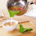 Green silicone soup funnel, 12 x 3 x 4.5 cm, clipped to edge of round pot for pouring