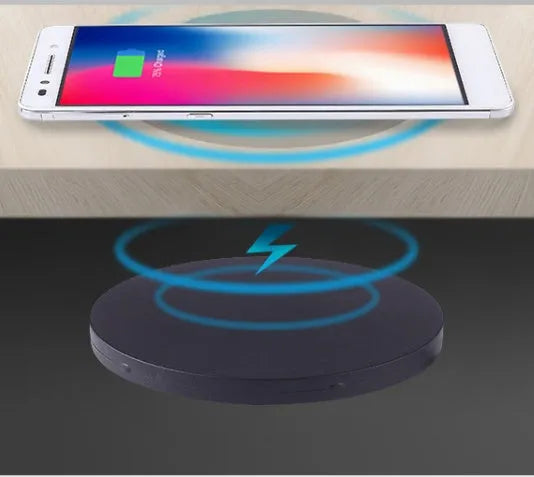 Black round 60mm wireless charging pad for embedded installation in desks and furniture.